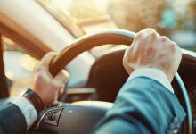 Two hands on steering wheel