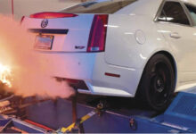 Car being tested on dynamometer with fire coming out of the back