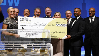 Group of people holding giant check at the First Look for Charity event