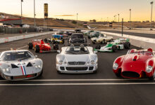 Collection of race cars from various eras on racetrack