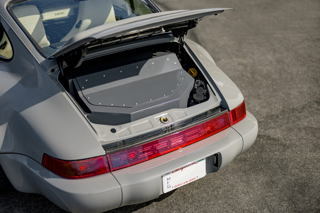 Open trunk of Electrified Porsche 911 (964) revealing battery