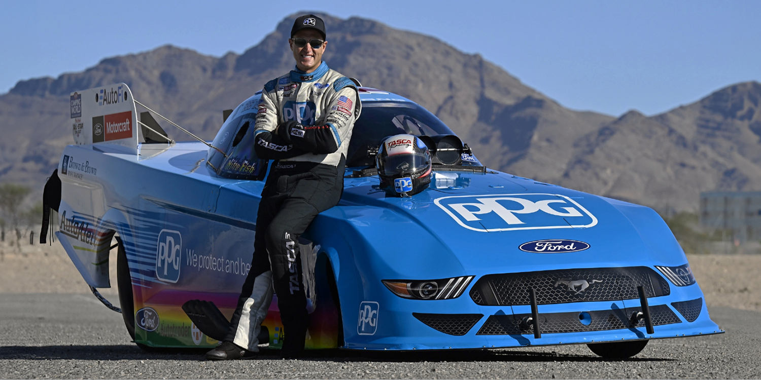 Bob Tasca III leaning against PPG Nitro Mustang Funny Car