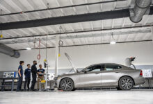 Students working on car in shop classroom