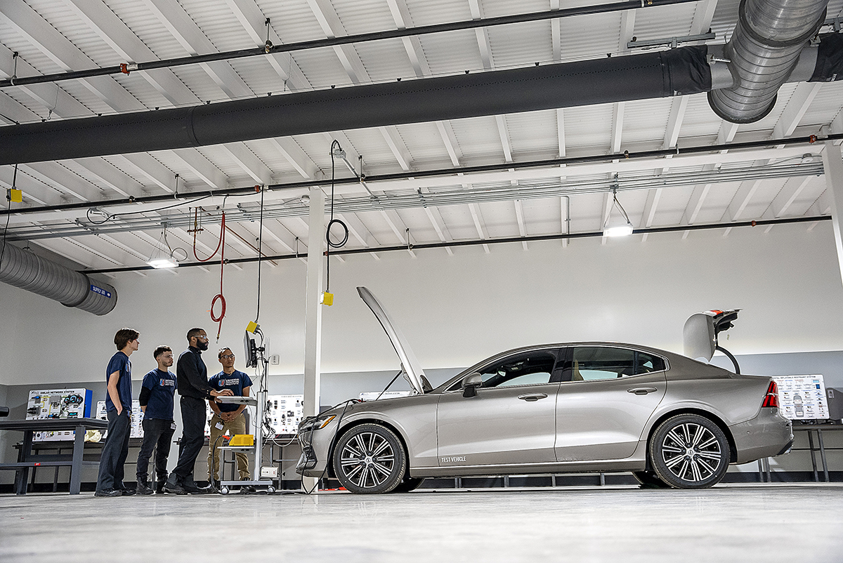 Students working on car in shop classroom