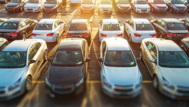 New vehicles in stock on dealer parking Lot.