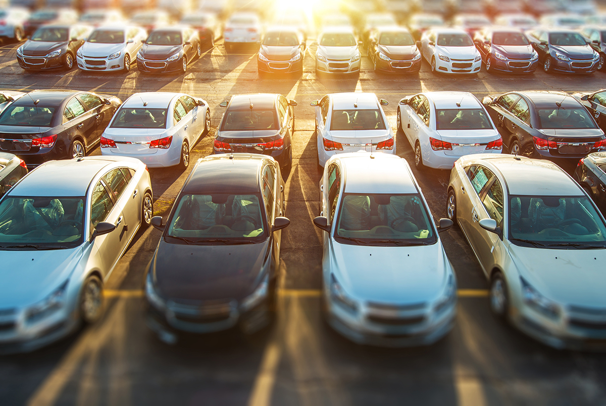 New vehicles in stock on dealer parking Lot.