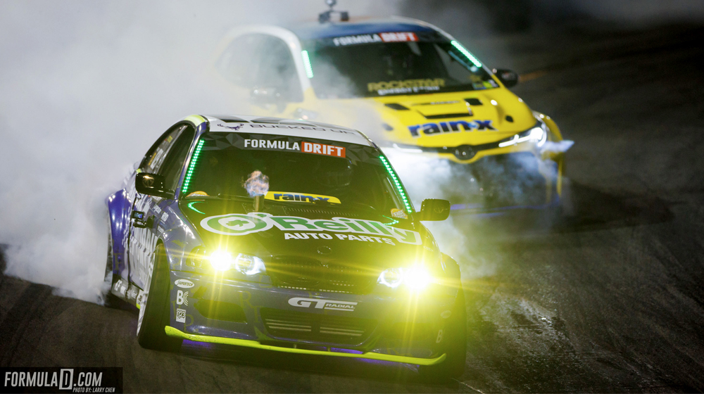 Two cars with smoking tires in Formula DRIFT event