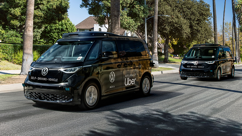ID Buzz autonomous vehicles with Uber logos driving on road