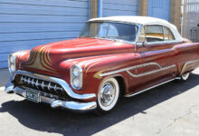 1953 Oldsmobile 88 Convertible Customized by George Barris & Dean Jeffries parked in front of garage doors