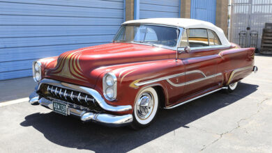 1953 Oldsmobile 88 Convertible Customized by George Barris & Dean Jeffries parked in front of garage doors