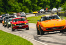 2024 hot rod power tour with a line of cars driving on road
