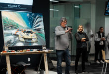 Bill Patterson presenting painting at auction for Austin Hatcher Foundation
