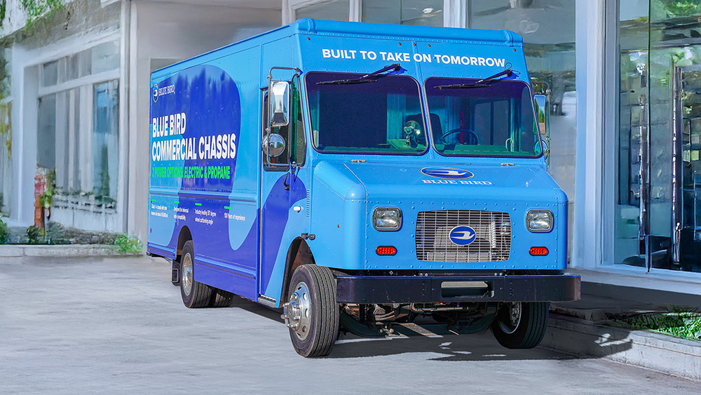 Blue Bird electric step van parked outside building