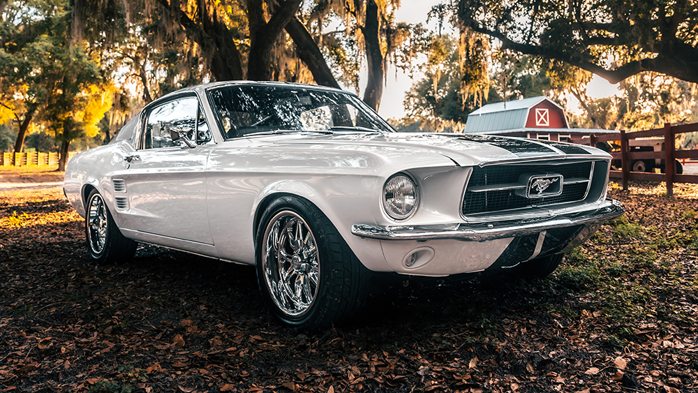ECD Automotive Design Project ‘67 Ghost-a 1967 Mustang Fastback parked under trees in front of barn