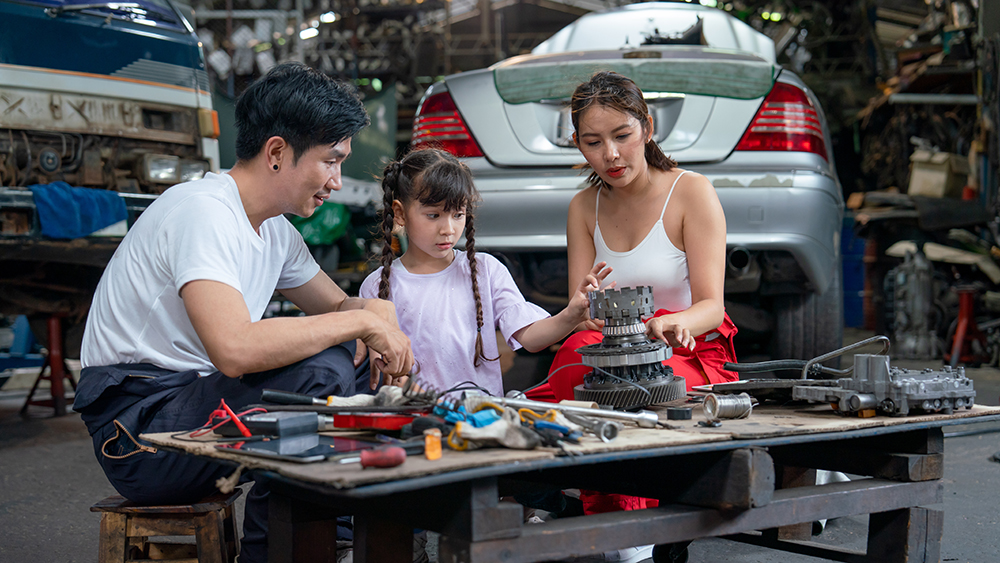 Asian family of mechanic enjoy to have good activity together in