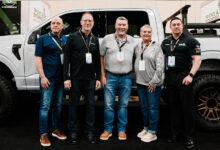 Group of people in front of F-150 customized by RealTruck at 2025 Big Money Show