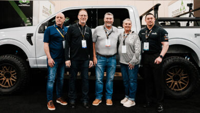Group of people in front of F-150 customized by RealTruck at 2025 Big Money Show