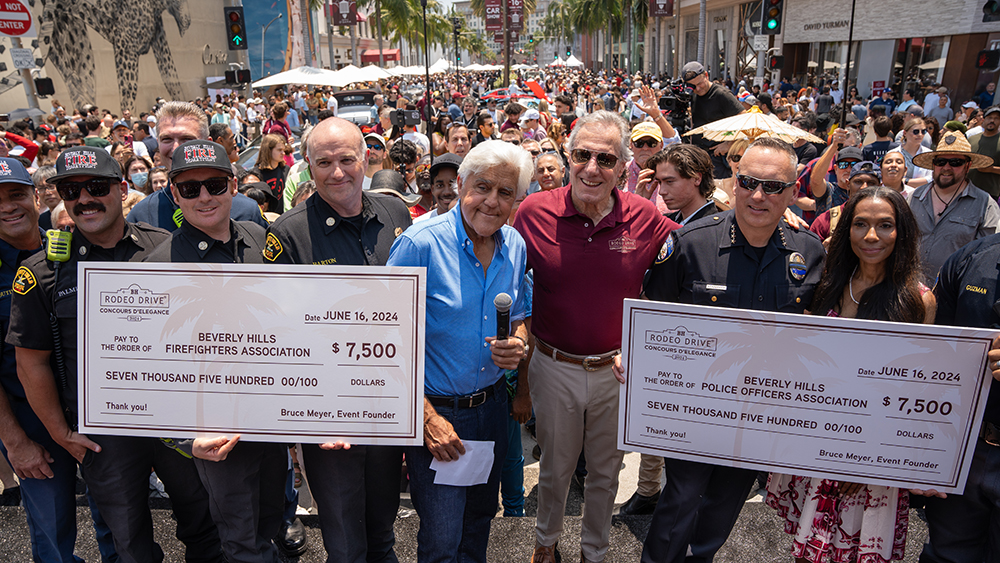 Jay Leno presenting giant checks to firefighters and police associations of Beverly Hills