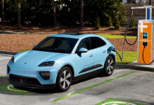 Porsche EV plugged into charging station in parking lot