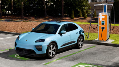 Porsche EV plugged into charging station in parking lot
