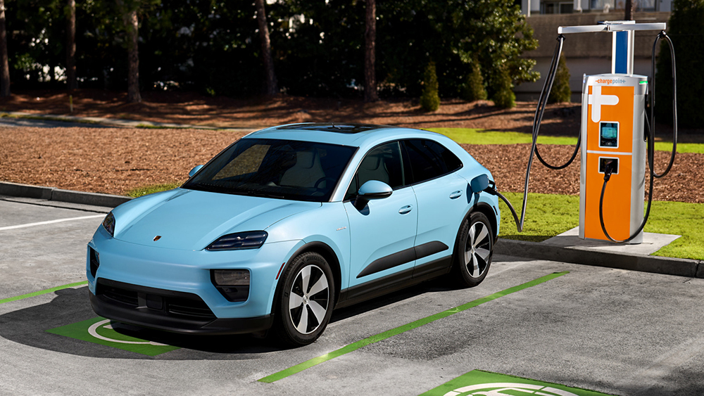 Porsche EV plugged into charging station in parking lot
