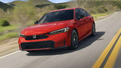 Red 2025 Honda Civic Sedan driving on road