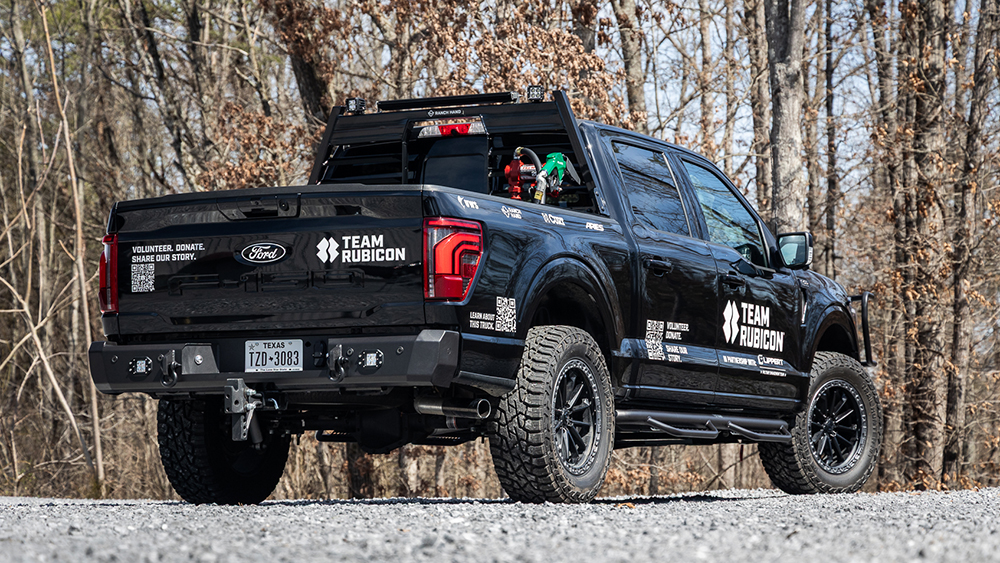 Team Rubicon F-150 from rear parked on gravel