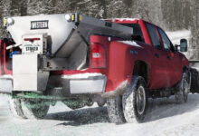 Truck outfitted with Western equipment on a snowy road