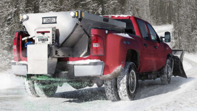 Truck outfitted with Western equipment on a snowy road