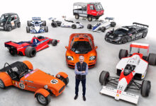 Gordon Murray standing amid car examples from 60 years of car design