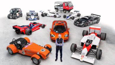 Gordon Murray standing amid car examples from 60 years of car design
