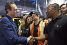Antonio Filosa greets a Windsor Assembly Plant employee during an event celebrating Chrysler’s 100th anniversary