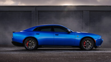 Blue 2026 Dodge Charger Daytona Sedan parked in front of wall at sunrise