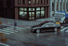 Car driving on street with pedestrian in crosswalk