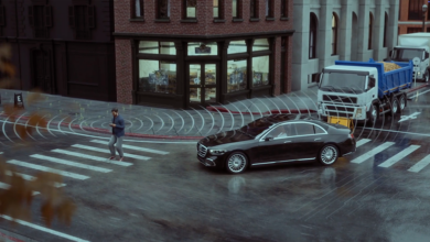 Car driving on street with pedestrian in crosswalk