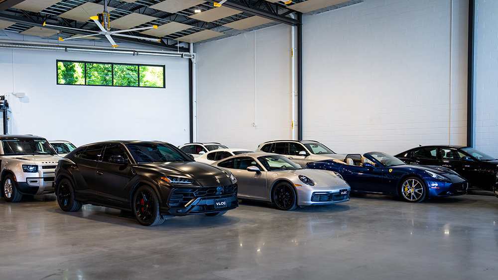 Collection of luxury cars in parking garage