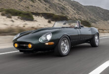 Jaguar E-Type GTO driving on road