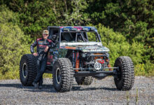 Jim Marsden standing next to his Bad Penny off-road racer