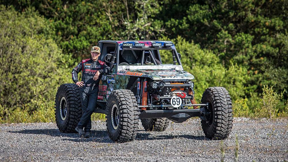 Jim Marsden standing next to his Bad Penny off-road racer