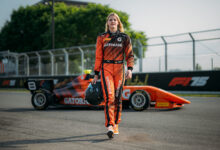 Mathilda Paatz wearing Gatorade suite and walking away from Gatorade car on racetrack