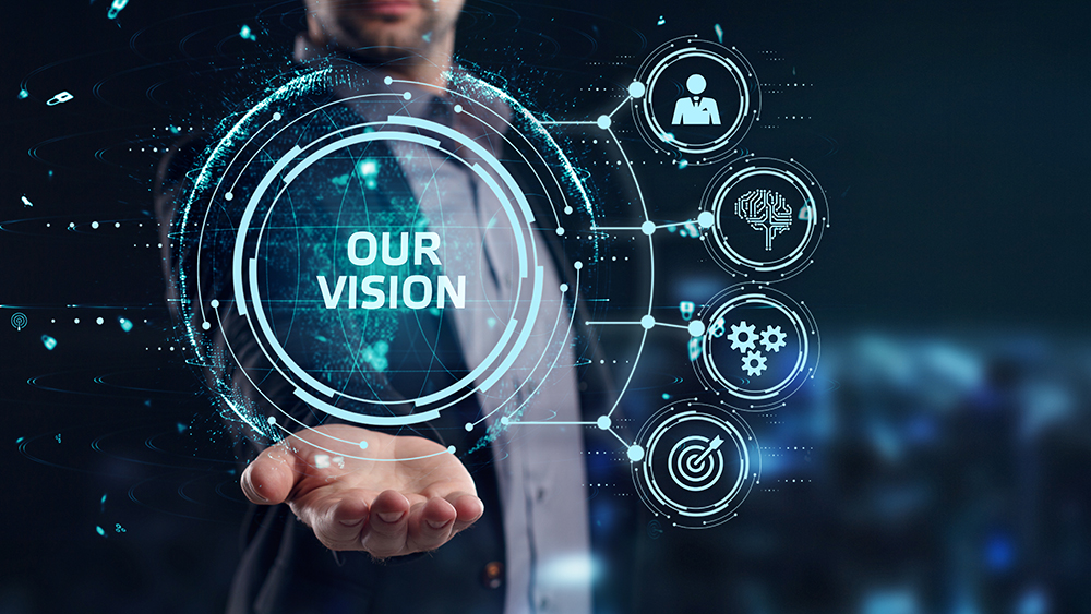 Person holding illustratoin of Our Vision graphic for business