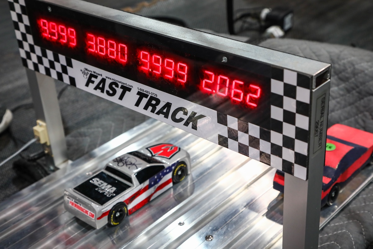 sema cares pinewood derby fundraiser car crosses finish line