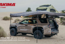 SUV parked in sand coverd by the Yakima OverNOut 180 Awning