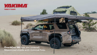 SUV parked in sand coverd by the Yakima OverNOut 180 Awning