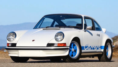 Classic whit Porsche Carrera parked on gravel