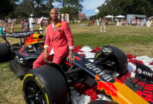 Arthur AJ Chipman, CEO & president of Formula GT sitting on race car.