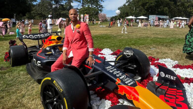 Arthur AJ Chipman, CEO & president of Formula GT sitting on race car.