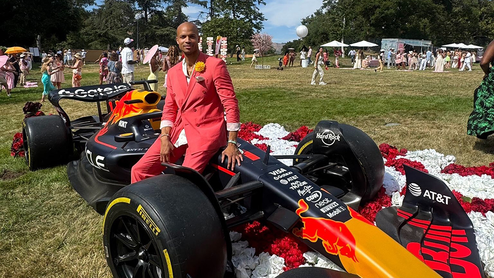 Arthur AJ Chipman, CEO & president of Formula GT sitting on race car.