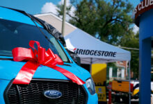 Front of van with ribbon donated by Bridgestone