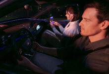 Passenger playing AirConsole while vehicle is in motion — front-seat display experience